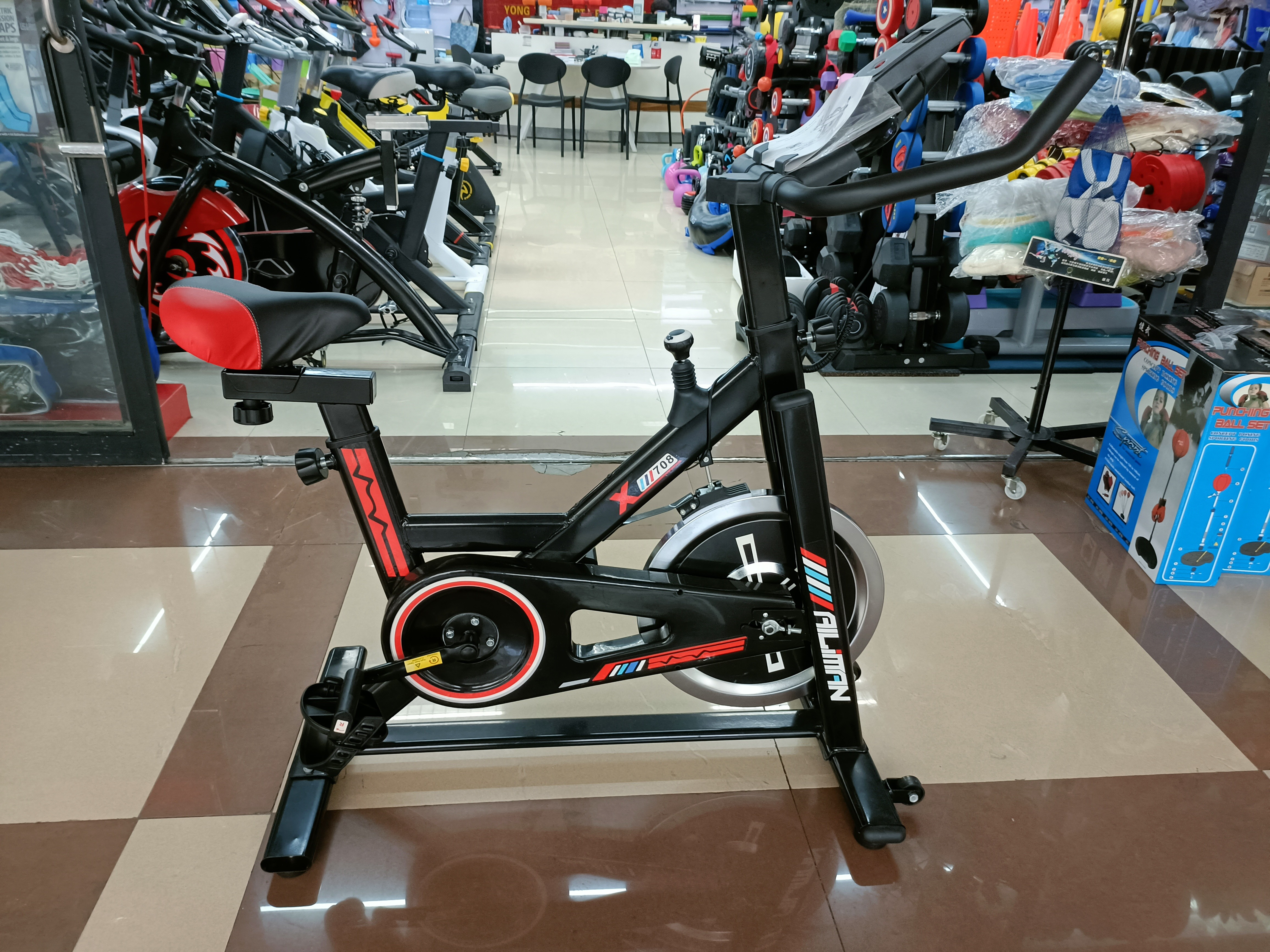 Smart black and red spinning bike home fitness room