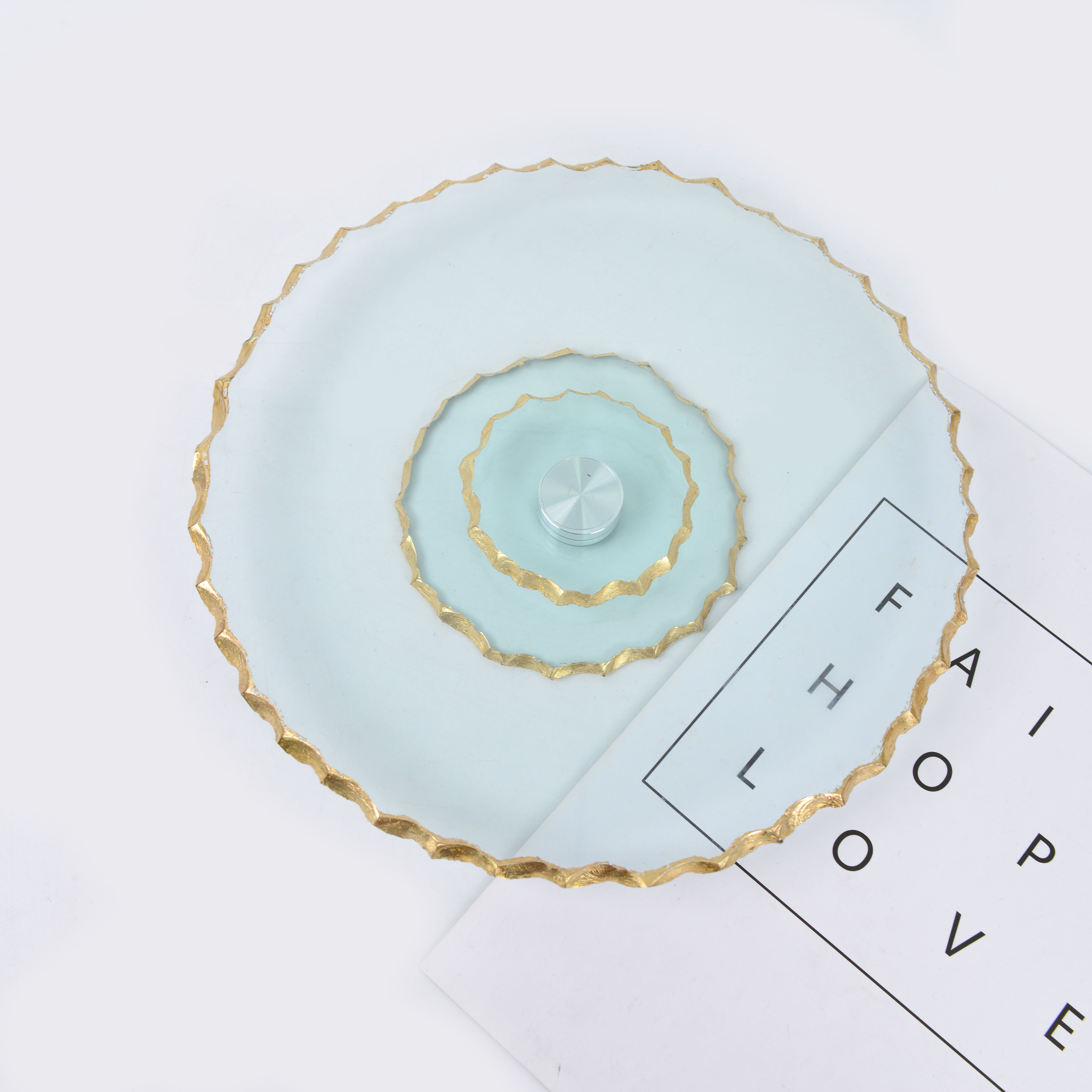A transparent gold-rimmed glass fruit platter without handles