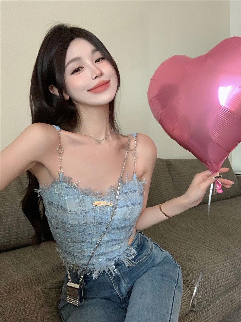 The blue fringed halter top is a sweet and spicy summer outfit for women. It has a pure and chic design and is paired with a short top inside