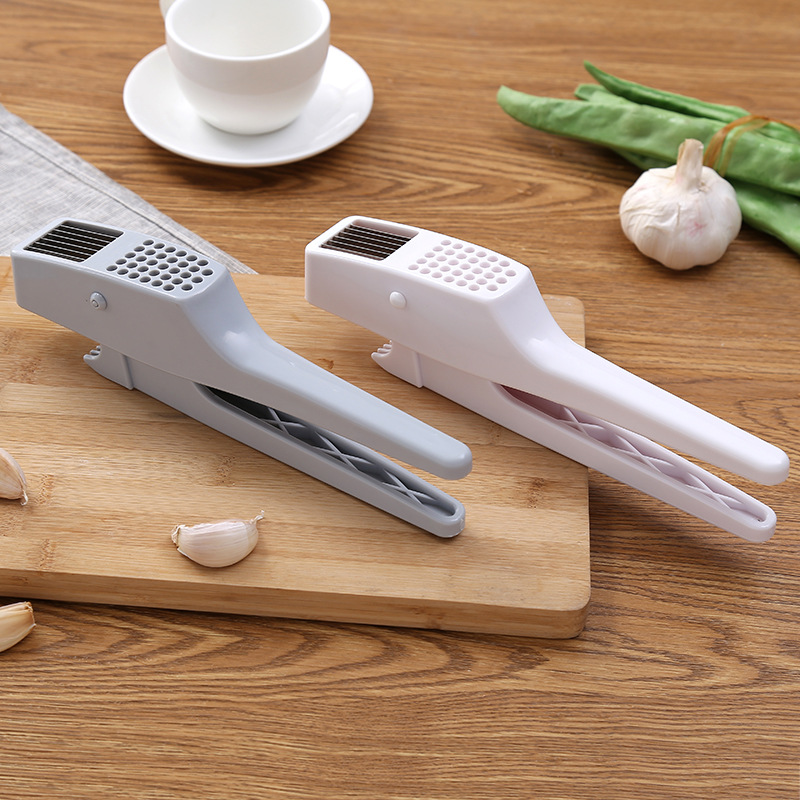 Multi-functional garlic press