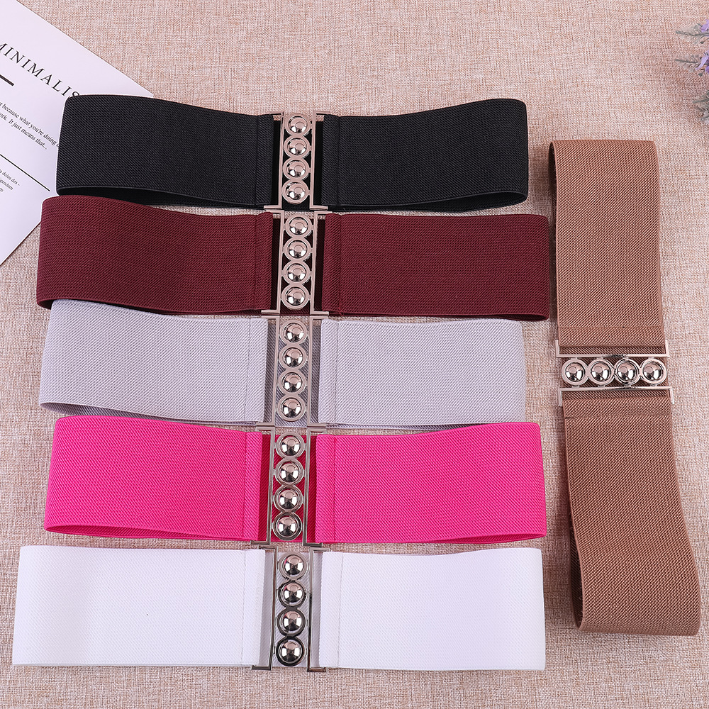 This is a fashionable lady's dress with a pearl button-down, elastic and tight waist belt that is versatile. It is decorated with an elastic waistband and a corset