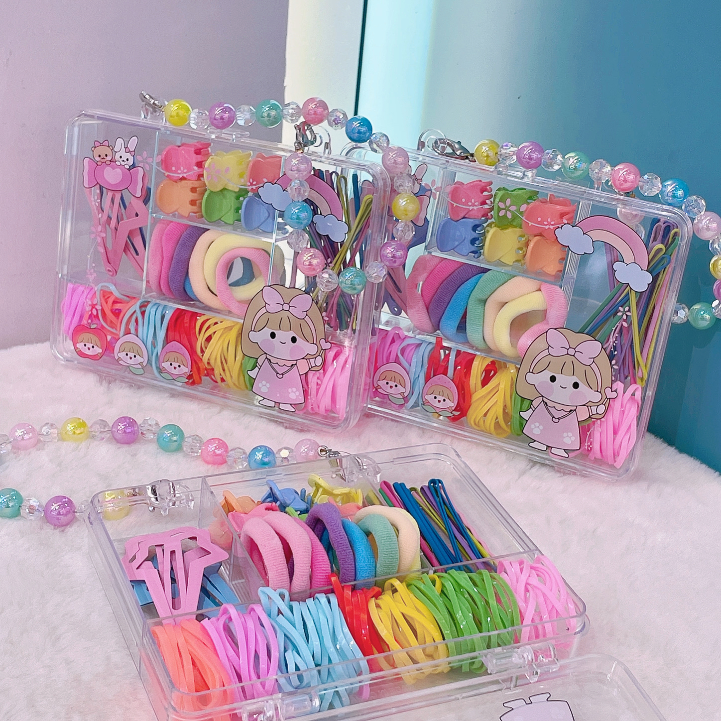The five-compartment box with a seven-color pearl chain features an exquisite design and a cute hairpin. It is a combination of various children's headwear, simple and elegant. It is a must-have gift for princess festivals and can be used as a decorative item Specification image