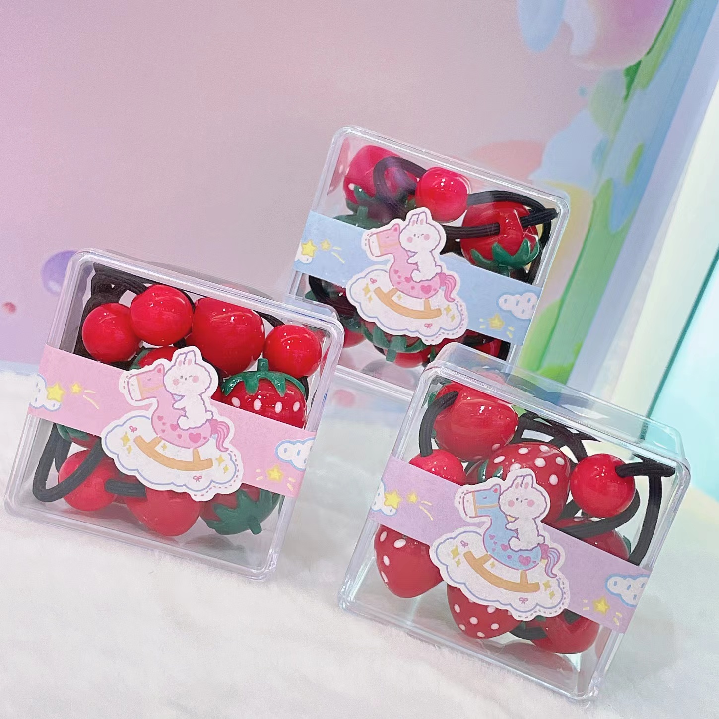 The classic red strawberry rubber band in the square box series is a cute and affordable 6-piece set with bright colors