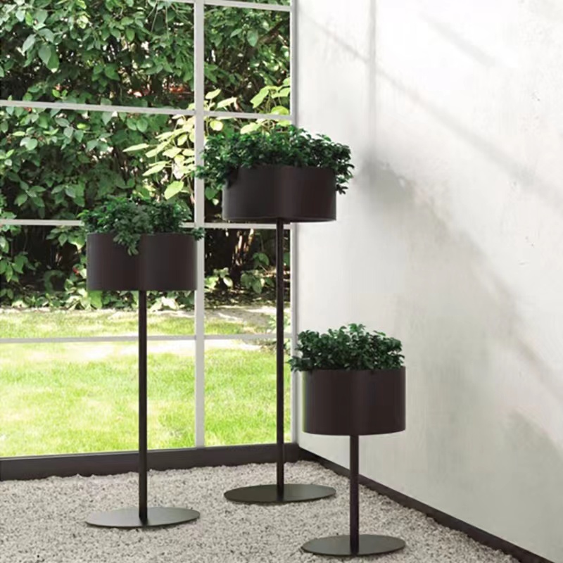 A Nordic-style flower stand beside the TV cabinet in the living room, a single floor-standing light luxury display item, and a green plant stand indoors details Picture