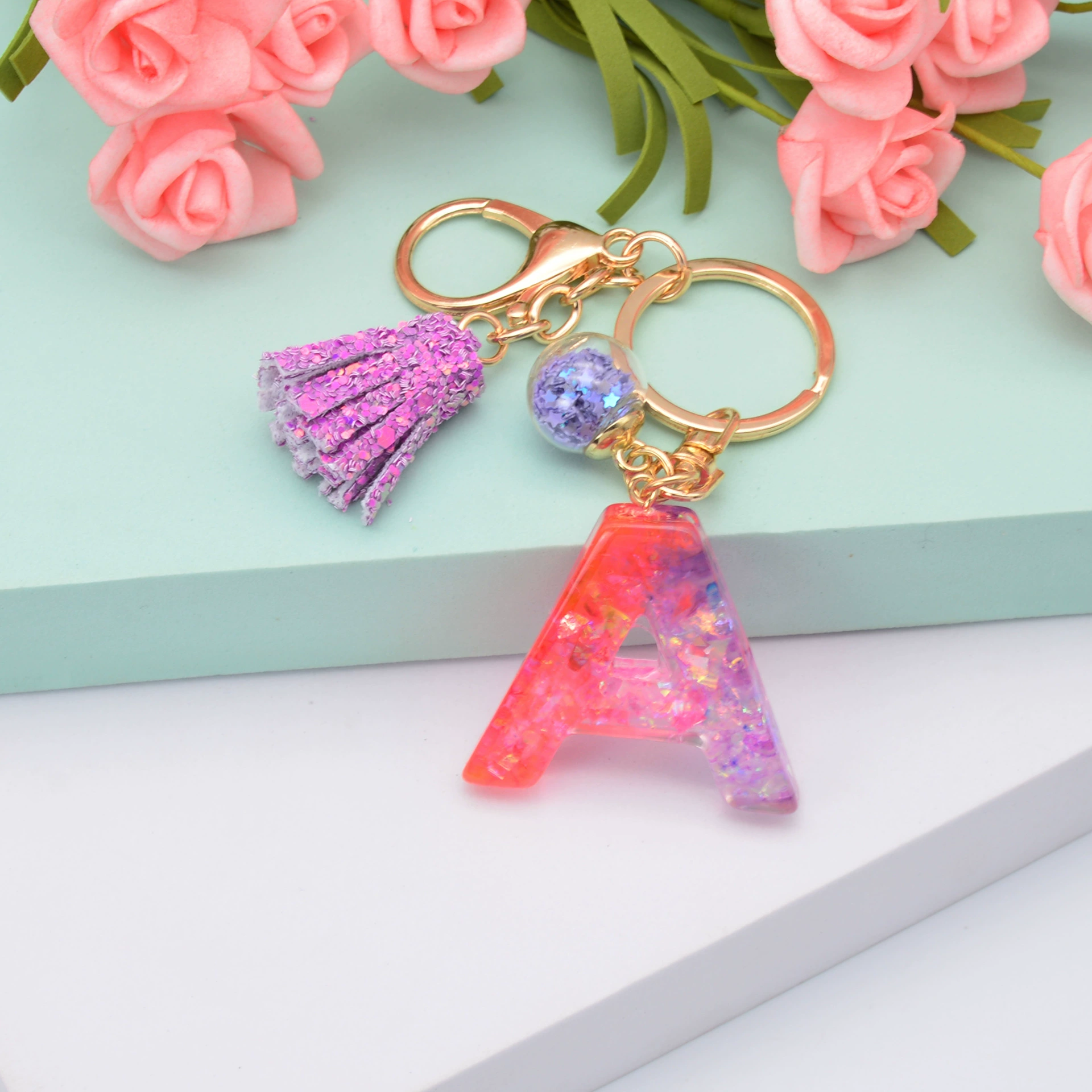 新款闪粉流苏字母钥匙扣水晶滴胶紫色葱粉挂件女士包包小礼品配饰  87详情图6