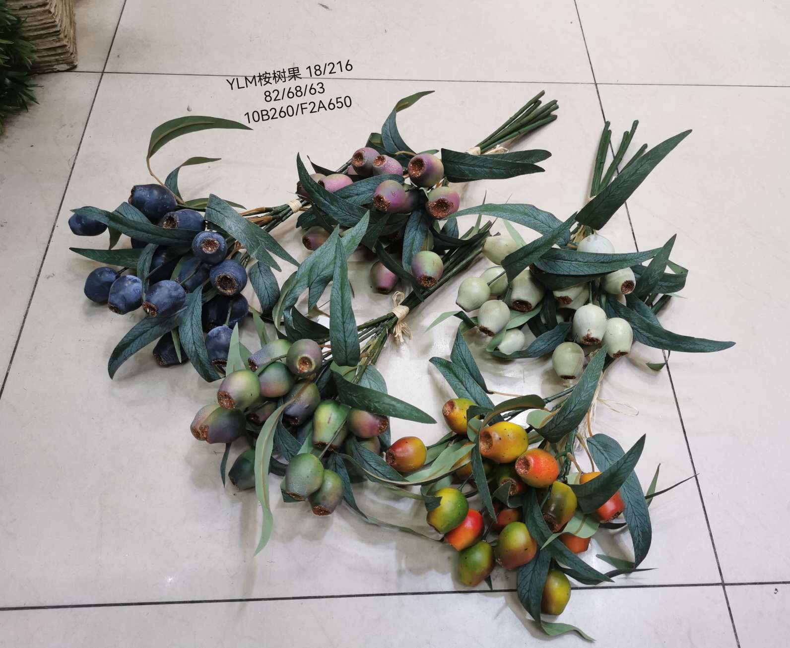 Wedding video: The bride holds a bouquet of flowers and makes a bouquet. Home decoration: living room, conference hall, hotel lobby. Realistic hand-made eucalyptus fruits are placed