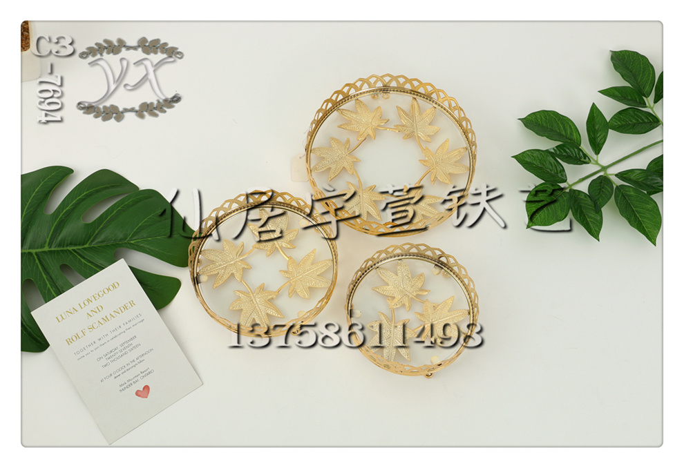 Yuxuan Ironwork offers a variety of specifications, including European-style round-mouth glass mirror hollowed-out ironwork fruit plates, living room household coffee tables, candy and snack basins. 52