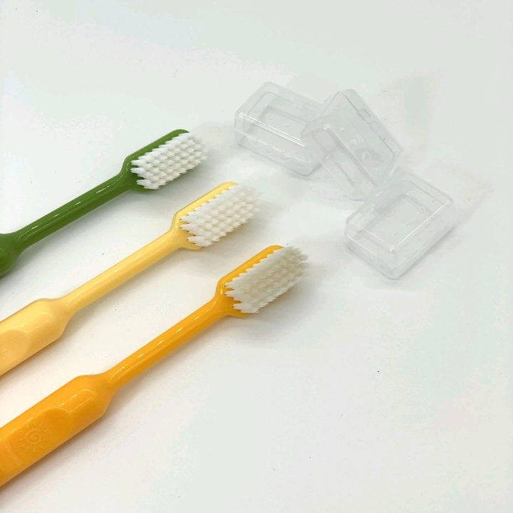 Three soft-bristled adult household toothbrushes with fresh covers for daily cleaning and care in a box detail image 2