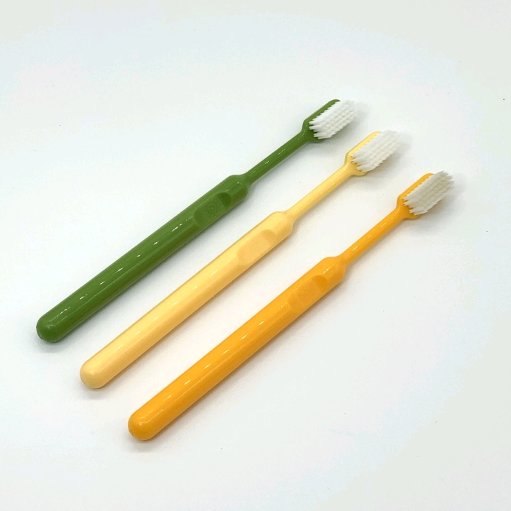 Three soft-bristled adult household toothbrushes with fresh covers for daily cleaning and care in a box detail image 3